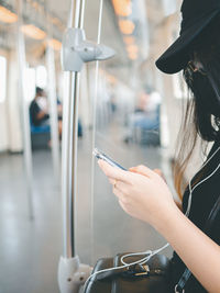 Midsection of woman using mobile phone