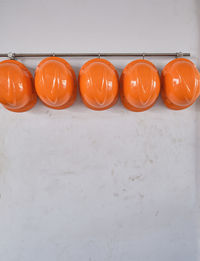 High angle view of orange eggs against white wall