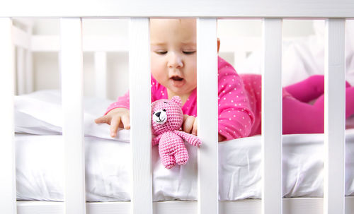 High angle view of baby boy sleeping on bed at home