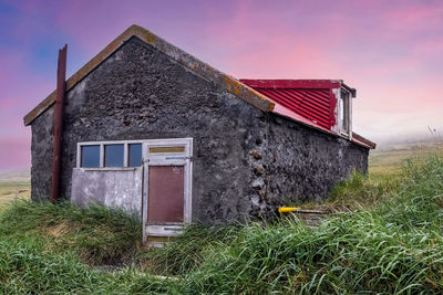 House on field against sky