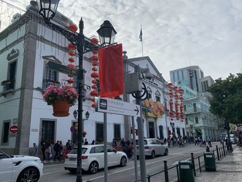 Vehicles on road against buildings in city