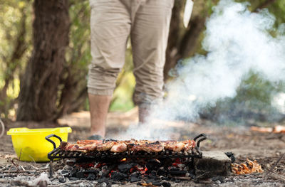 Man preparing meat on barbecue grill
