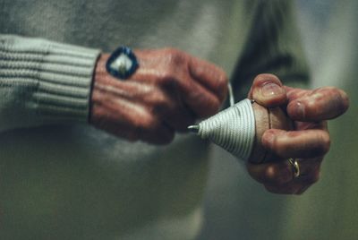 Midsection of person holding spinning top