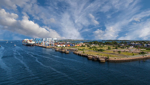 Panoramic view of sea and buildings against sky