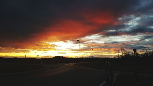 Road against dramatic sky during sunset