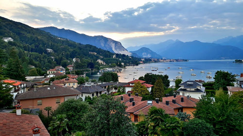 Scenic view of town by mountains against sky
