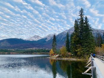 Scenic view of lake by mountains against sky