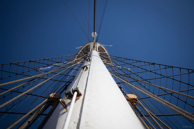 Low angle view of sailboat against clear blue sky