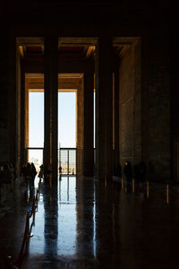 Silhouette people walking in building