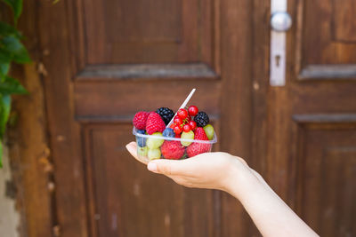 Midsection of person holding fruits