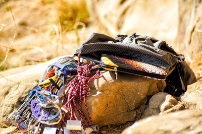 Safety harnesses by bag on rock