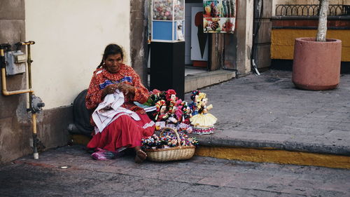 Woman sitting in basket for sale