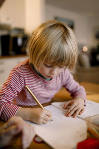 Boy doing homework at table