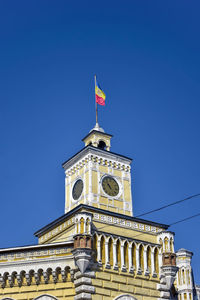 Moldovan flag is fixed on clock tower of old municipality building in chisinau, moldova. copy space.