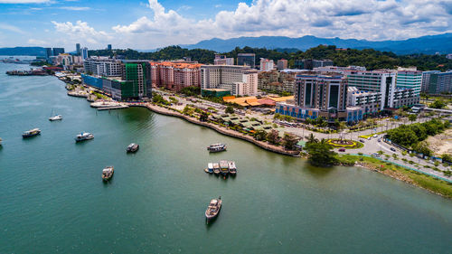 High angle view of river and cityscape against sky