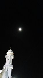 Low angle view of illuminated building against sky