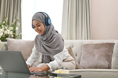 Young woman using laptop at home