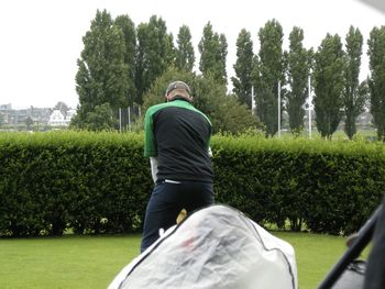 Rear view of golfer taking shot