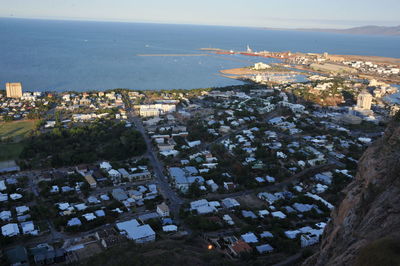 High angle view of townscape by sea against sky