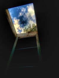 Low angle view of building against cloudy sky