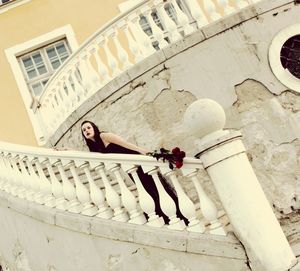 Tilt shot of fashion model standing on staircase
