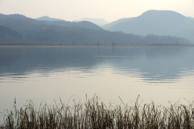 Scenic view of lake and mountains against sky