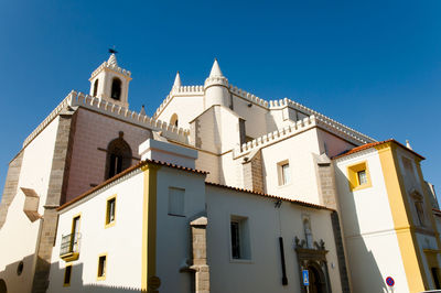 Low angle view of building against clear blue sky