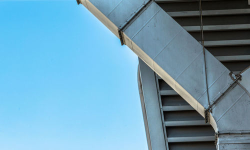 Low angle view of building against clear blue sky