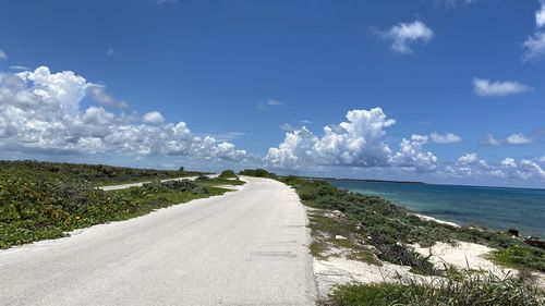 Road by sea against sky