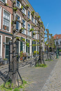 Bicycle on sidewalk by building in city