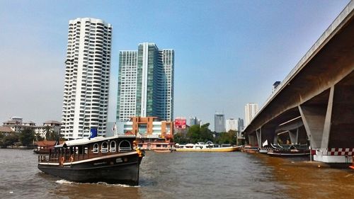 Boat in city against clear sky