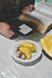 High angle view of woman preparing food on table