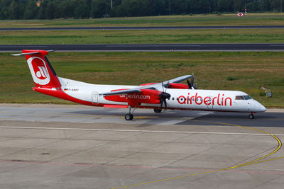 Side view of airplane on airport runway