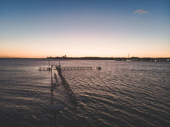 Scenic view of sea against clear sky at sunset