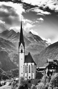 Church and buildings against mountains and sky