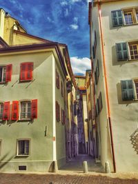 Buildings against cloudy sky