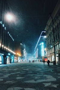 Illuminated city street at night