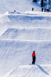 People skiing on snow covered mountain