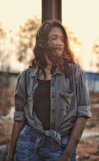 Mid adult woman standing against black background