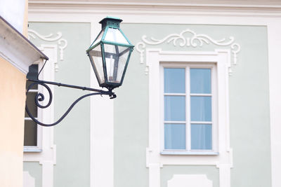 Low angle view of street light against building