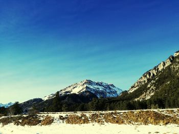 Scenic view of mountains against clear blue sky