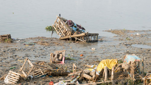 Polluted holy ganga riverbank by religious rituals after durga puja idol immersions