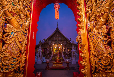 Illuminated at wat ming muang against sky at twilight