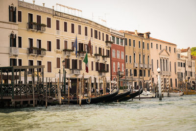 Boats in canal against buildings in city