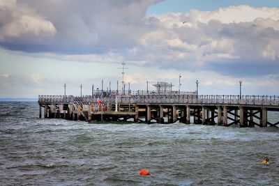 Pier over sea against sky