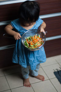 Midsection of girl holding food