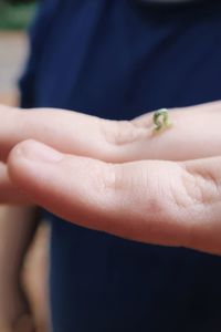 Close-up of hand holding small outdoors