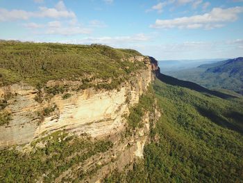 Scenic view of mountains against cloudy sky