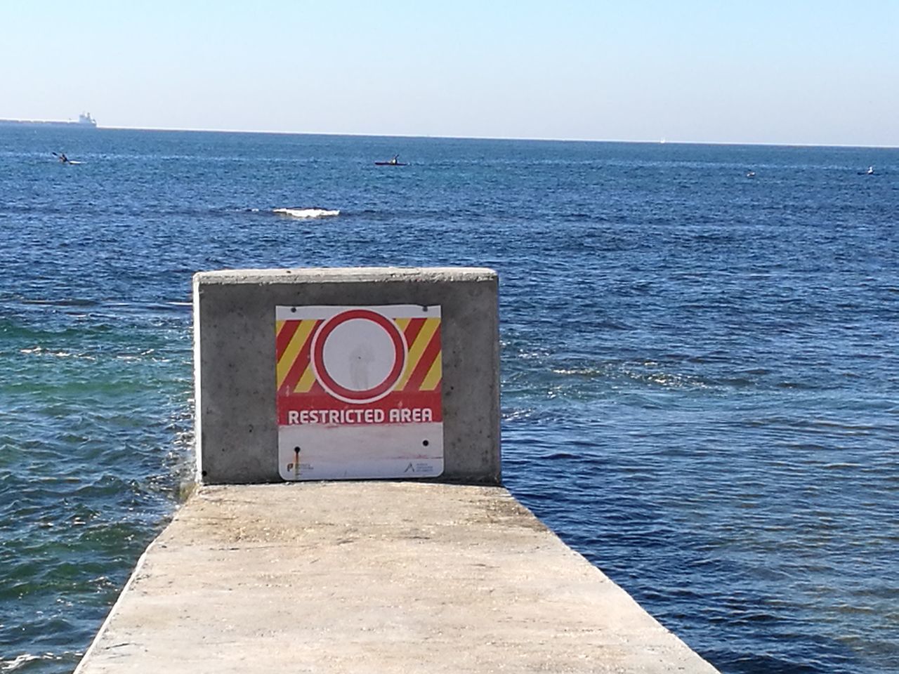 SIGN BY SEA AGAINST CLEAR SKY