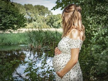 Woman standing by lake